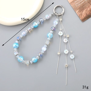 Détails du porte-clés perlé avec fleurs bleues, glands et fermoir à anneau argenté poli