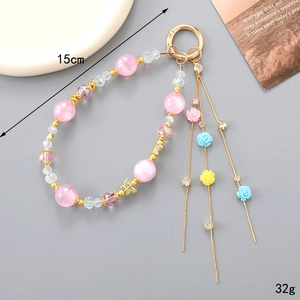 Bijou de téléphone floral perlé avec pompons et pendentif papillon en métal coloré