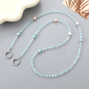 Macro shot of colorful faceted crystal beads and silver metal rings for bag strap