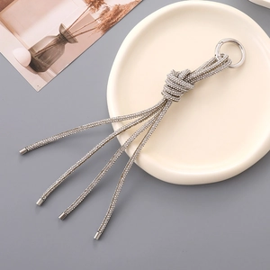 Close-up of luxury knotted rhinestone tassel charm with a silver spring ring clasp
