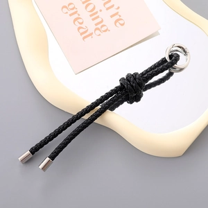 Classic black braided PU leather keychain with silver metal ring and decorative knot detail