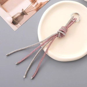 Close-up of pink and silver crystal rhinestone knotted keychain with metallic ring