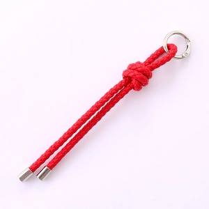 Handmade red braided leather car keychain with silver metal ring clasp on white background