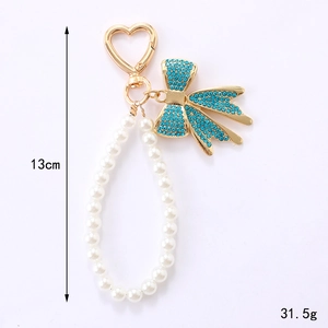 Porte-clés nœud et perles élégant avec strass bleus et fermoir cœur, longueur de 13 cm