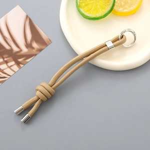 Close-up of khaki hand-woven nylon rope keychain with silver spring carabiner hook