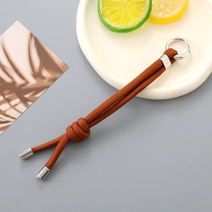 Detailed view of dark brown hand-woven nylon cord keychain with silver spring clasp