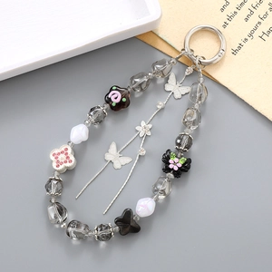 Detail of beaded wristlet keychain with butterfly pendant and star charms for phone cases