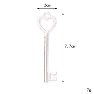 Silver alloy hollow heart key charm with ribbon bow design, dimensions 7.7x2 cm