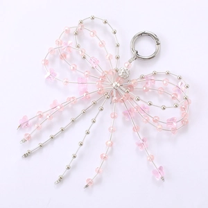 Pink crystal bow charm featuring silver beads and a rhinestone ball for bags or phones