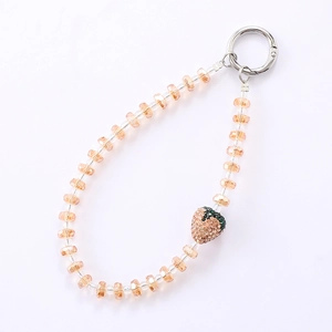 Champagne beaded phone strap with sparkling rhinestone strawberry pendant and silver clasp