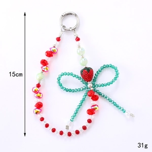 Bijou de téléphone fraise fait main avec nœud vert et anneau en métal argenté de 15 cm