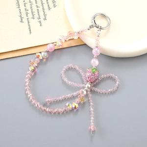 Dragonne de téléphone avec fraise en cristal rose noeud et perles scintillantes accessoires