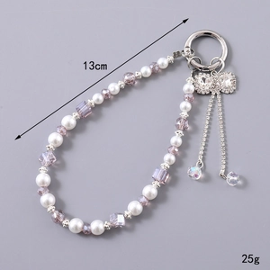 Luxurious pearl and crystal beaded phone wrist strap with rhinestone bow and fringe