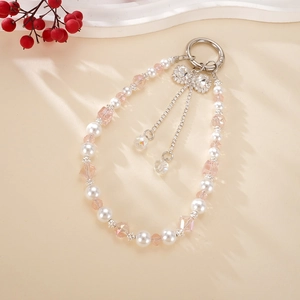 Detail of beaded keychain featuring pink crystals, pearls, and a rhinestone bow charm
