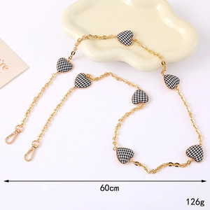 Detail showing 60cm golden houndstooth chain strap with heart pendants and lobster clasps