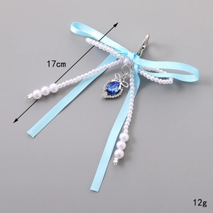 Light blue double bow keychain with white pearls and dark blue teardrop crystal pendant