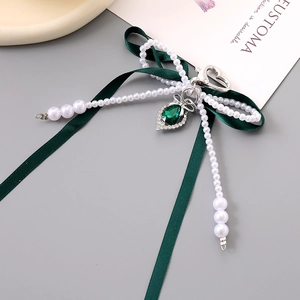 Elegant emerald green double bow keychain with drop pendant and heart metal clasp accessory
