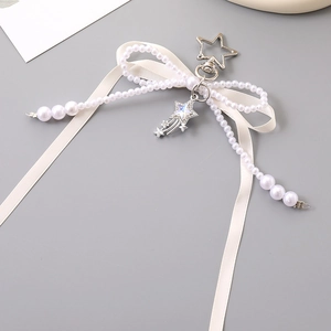 White satin ribbon bow charm with pearl beads and colorful star meteor pendant