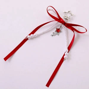 Red satin bow keychain with white pearls and a star pendant on a soft pink surface