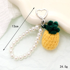 Handmade crochet pineapple keychain with white pearls and heart clasp for bags