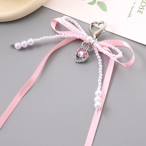 Porte-clés avec nœud en soie rose et perles blanches pour sacs ou téléphones