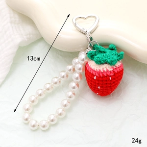 Handmade crochet strawberry phone charm with white faux pearls and heart metal clasp