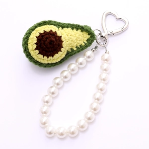 Handmade crochet avocado keychain with pearl strap and heart metal clasp on white background