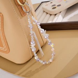 Elegant beaded bag charm featuring purple pearls, silver butterfly, and rhinestone tassels