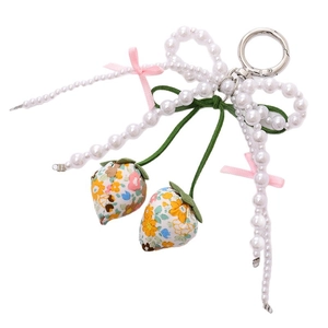 Floral strawberry keychain with white pearls and pink ribbon bow on white background