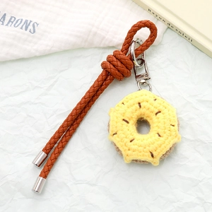 Handmade crochet donut charm with brown leather strap and silver metal clasp for bags