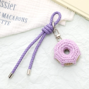 Handmade crochet donut keychain with purple knit icing and braided leather strap