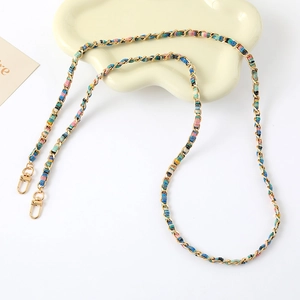 Detail of colorful woven fabric and gold metal chain with durable lobster clasps