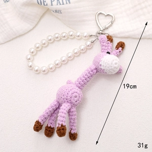 Handmade purple crochet giraffe phone charm with white faux pearls and heart clasp