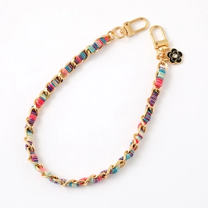 Handwoven colorful fabric strap with gold metal chain and black enamel flower pendant