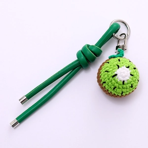Handmade crochet kiwi fruit bag charm with green leather strap and silver keychain
