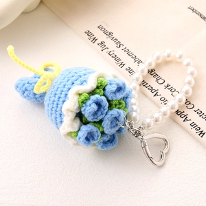 Detailed macro view of handmade crochet blue rose flower with elegant pearl handle strap