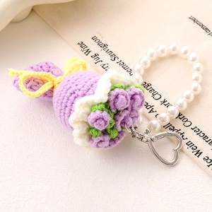 Handmade crochet flower pendant with pearls and heart clasp on vintage background