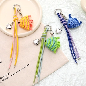 Handmade crochet fish bag charms with colorful leather tassels and heart pendants