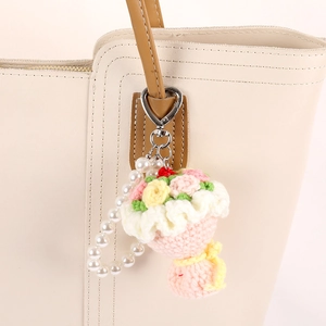 Handmade crochet rose bouquet charm with faux pearls and silver heart clasp on tote bag