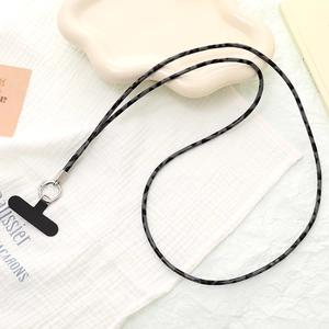 Close-up of stylish leopard print crossbody phone lanyard with silver metal ring