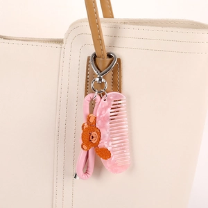 Porte-clés avec peigne rose marbré et ours orange pailleté sur anneau en cuir PU