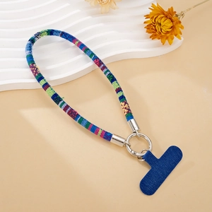 Detail view of ethnic woven phone wrist strap with blue tab and silver ring connector