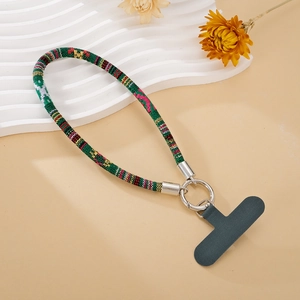 Close-up of ethnic woven phone wrist strap with silver metal clasp and gray t-patch
