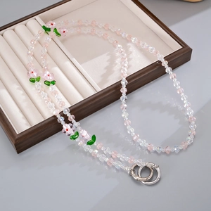 Floral beaded phone strap with pink glass flowers and silver spring rings in jewelry box