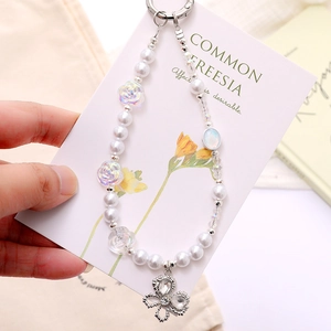 Elegant beaded phone strap with white pearls, rose charms and silver butterfly pendant