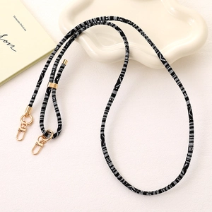 Ethnic woven phone lanyard with black and white jacquard pattern and gold metal buckles