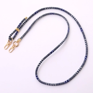 Ethnic style crossbody phone strap with blue and white woven pattern and gold lobster clasps