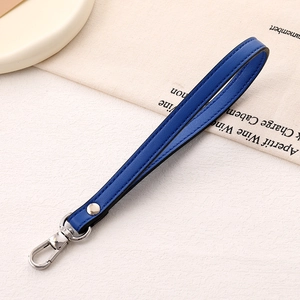 Detail view of the deep blue PU leather wrist strap with silver metal lobster clasp and rivet