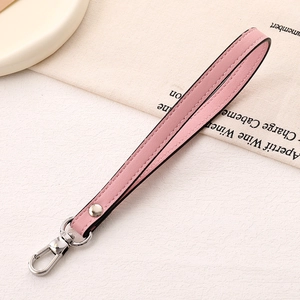 Pink lychee texture leather wrist strap with a silver metal lobster clasp for handbags