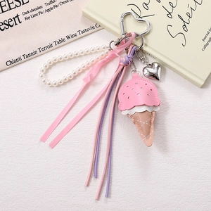Detail of sweet PU leather ice cream charm with pearls, ribbons and elegant metal heart buckle